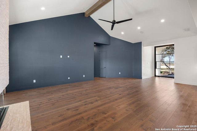 unfurnished living room with beam ceiling, high vaulted ceiling, ceiling fan, and wood finished floors