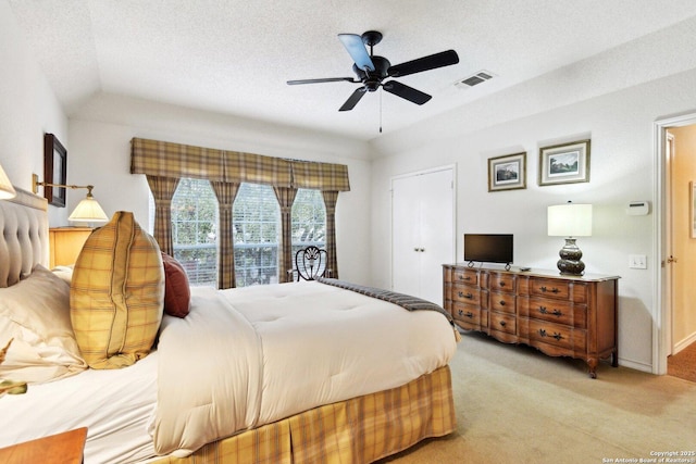 bedroom with visible vents, light carpet, and a textured ceiling