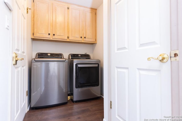 laundry area with dark wood-style floors, cabinet space, and washing machine and dryer