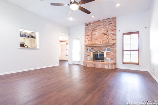 unfurnished living room featuring baseboards, a fireplace, recessed lighting, dark wood-style flooring, and ceiling fan