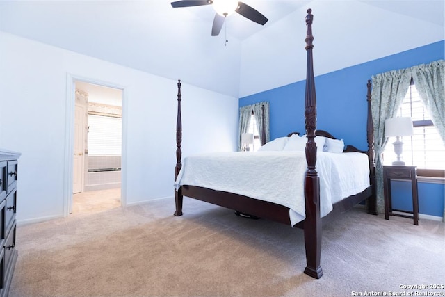 carpeted bedroom with connected bathroom, a ceiling fan, baseboards, and vaulted ceiling