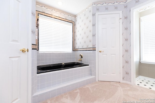 full bathroom featuring wallpapered walls, a bath, and baseboards