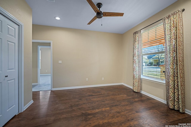 spare room with wood finished floors, recessed lighting, a ceiling fan, and baseboards