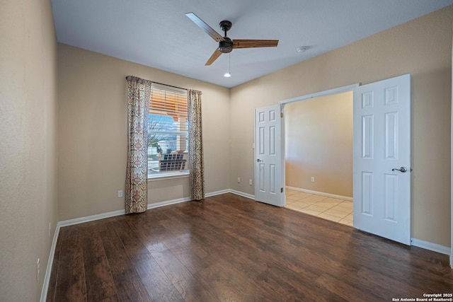 unfurnished bedroom with baseboards, wood finished floors, and a ceiling fan