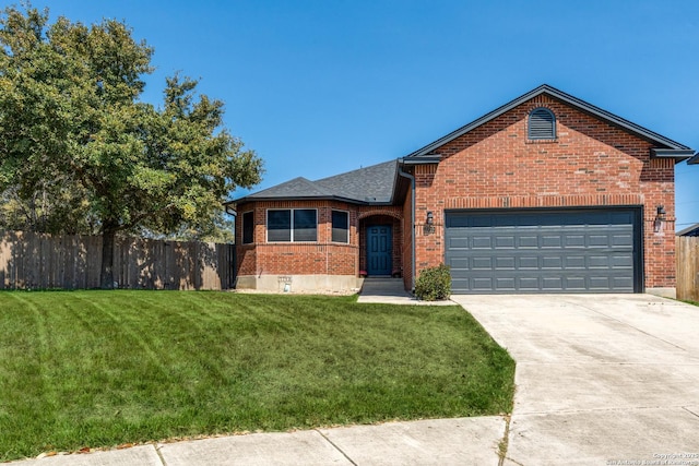 view of front of home featuring brick siding, an attached garage, a front lawn, fence, and driveway