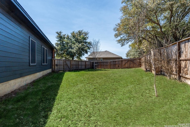 view of yard with a fenced backyard