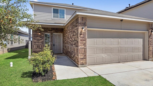 view of front of home with a garage, brick siding, concrete driveway, and a front yard