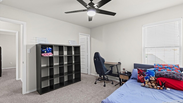 carpeted bedroom featuring baseboards and ceiling fan