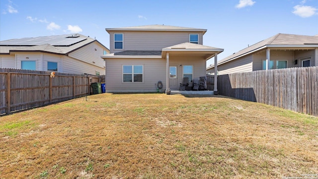 back of property featuring a lawn and a fenced backyard