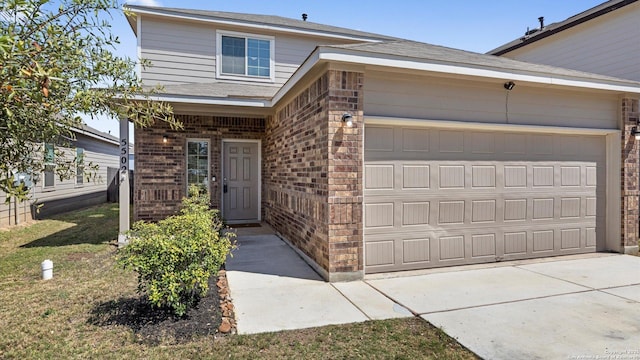 view of front facade with brick siding, concrete driveway, and an attached garage