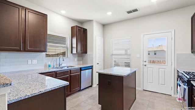 kitchen featuring dark brown cabinetry, visible vents, appliances with stainless steel finishes, and a sink