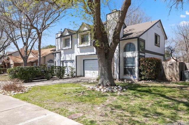 view of front of home featuring stucco siding, driveway, a front yard, a garage, and a chimney