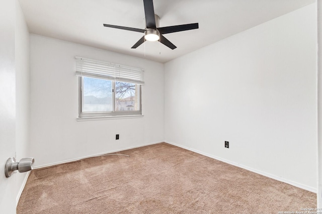 unfurnished room with a ceiling fan, carpet, and baseboards