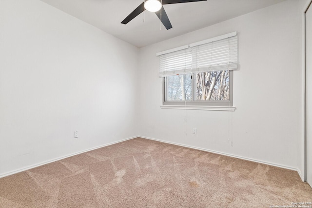 carpeted spare room with ceiling fan