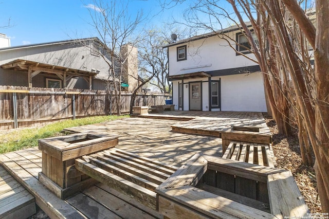 view of patio featuring a wooden deck and fence