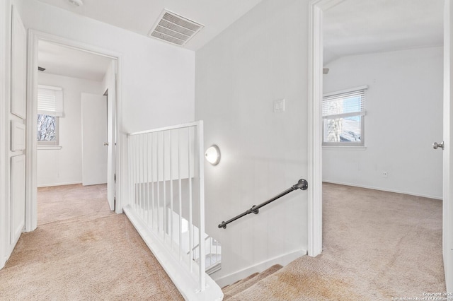 staircase with vaulted ceiling, baseboards, visible vents, and carpet floors