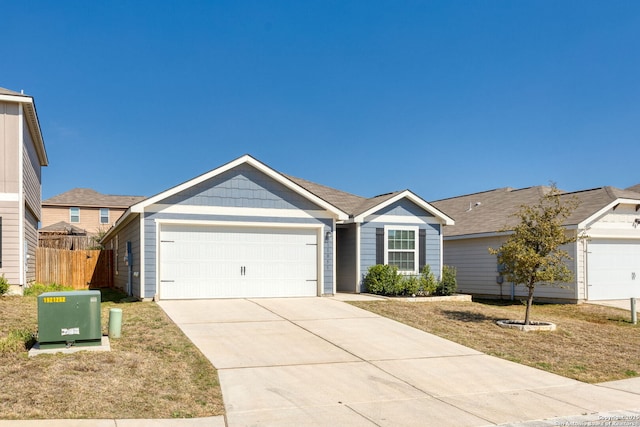 single story home with concrete driveway, an attached garage, fence, and a front yard