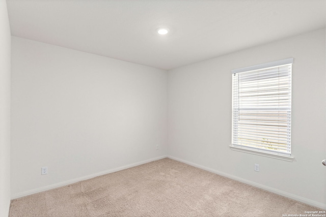 spare room featuring recessed lighting, baseboards, and carpet floors