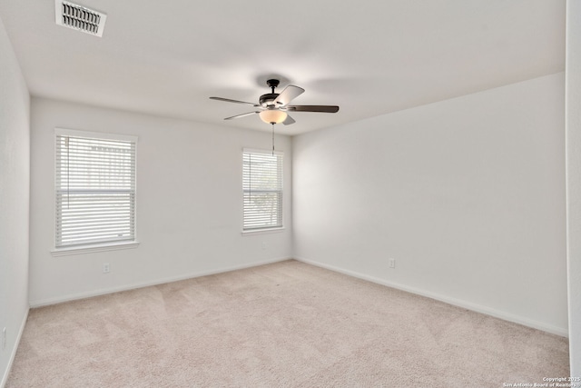 empty room featuring visible vents, baseboards, ceiling fan, and carpet floors