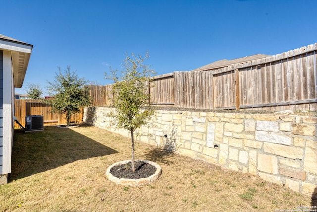 view of yard featuring central AC unit and a fenced backyard