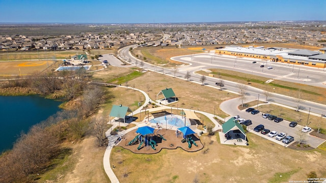 drone / aerial view with a residential view and a water view