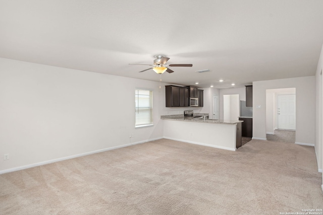 unfurnished living room with recessed lighting, light colored carpet, baseboards, and ceiling fan