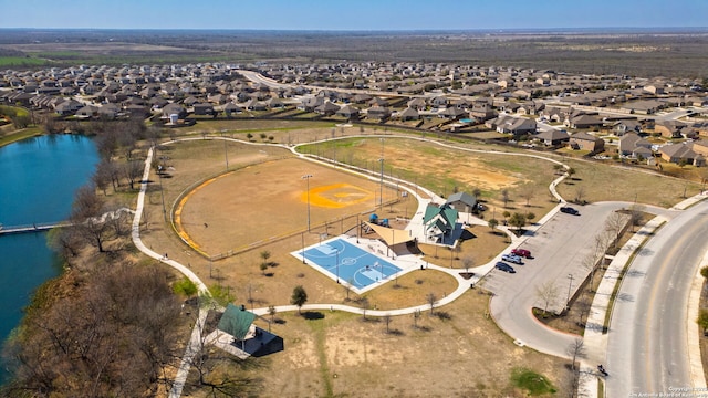 drone / aerial view with a residential view and a water view