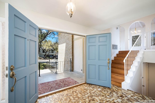 entryway with visible vents and stairs