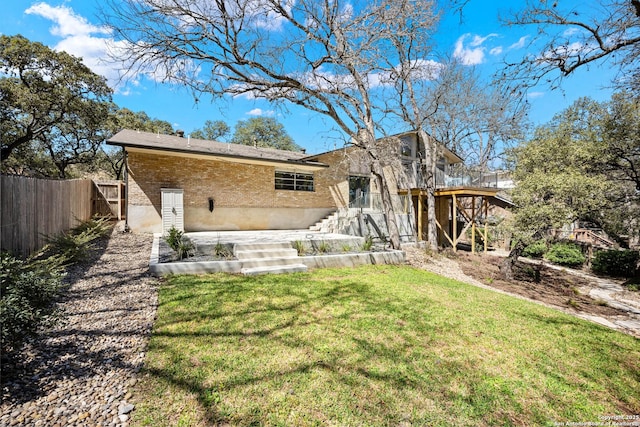 back of house with stairway, fence, a yard, a patio area, and brick siding