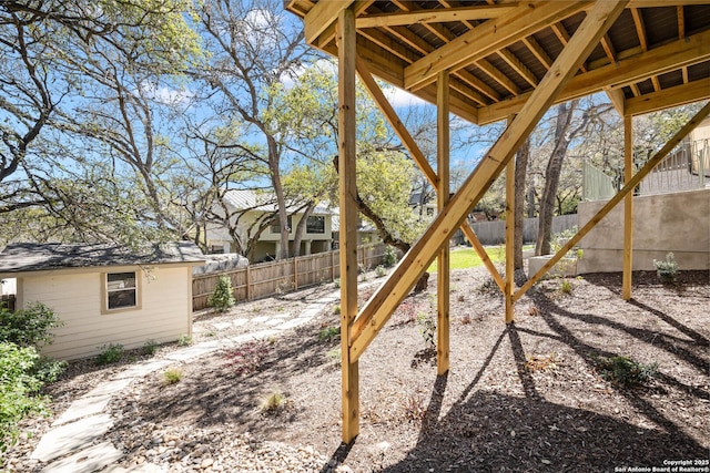 view of yard with a fenced backyard and an outdoor structure