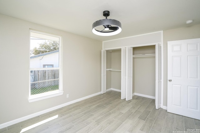 unfurnished bedroom featuring baseboards and wood finish floors