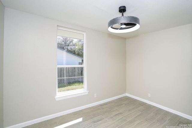 unfurnished room featuring wood finish floors and baseboards