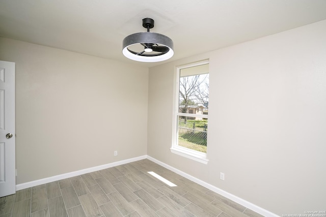 spare room with baseboards and wood tiled floor