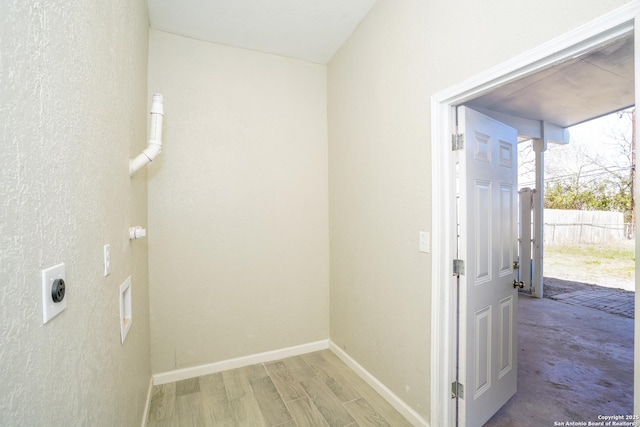 laundry area featuring laundry area, hookup for an electric dryer, baseboards, and wood finished floors