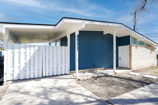 exterior space with a carport and fence