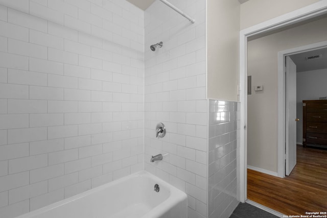 full bathroom with visible vents, wood finished floors, and bathtub / shower combination