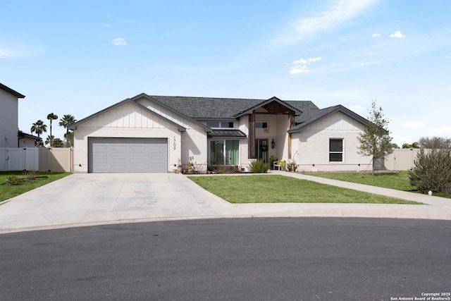 modern farmhouse style home featuring fence, concrete driveway, a front yard, a garage, and a gate