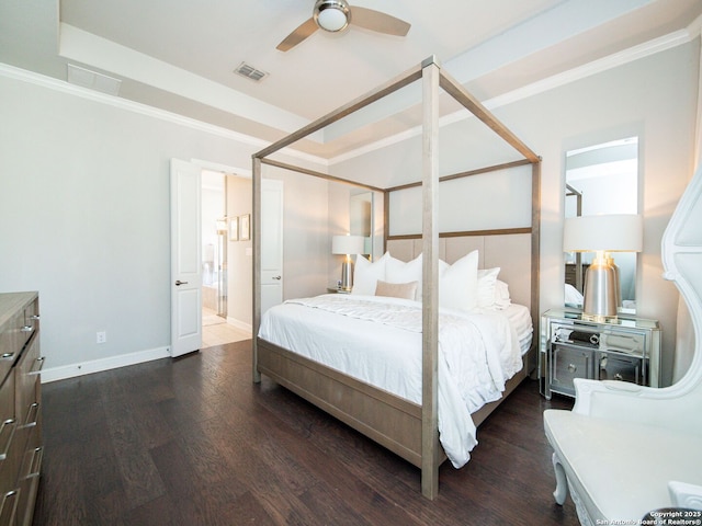 bedroom with visible vents, baseboards, and wood finished floors