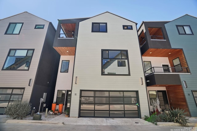 contemporary home with a balcony and a garage