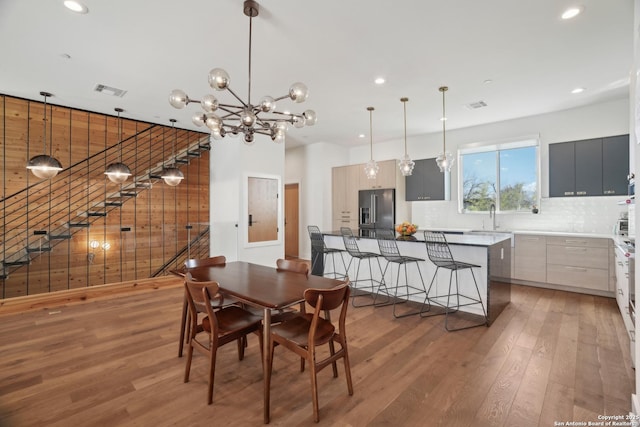 dining space featuring recessed lighting, visible vents, light wood-style floors, and an inviting chandelier