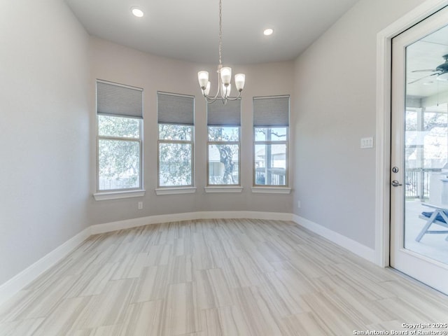 spare room featuring recessed lighting, light wood-style floors, baseboards, and a notable chandelier