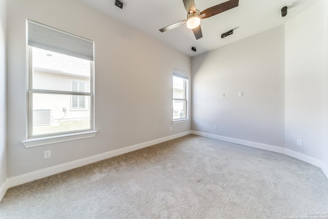 empty room featuring baseboards, carpet floors, and ceiling fan