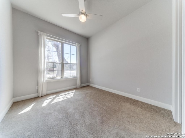 unfurnished room with carpet flooring, a ceiling fan, and baseboards