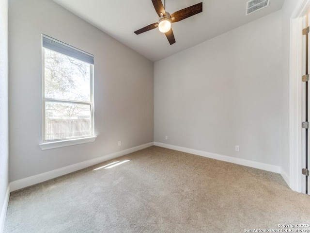 spare room featuring visible vents, baseboards, ceiling fan, and carpet flooring