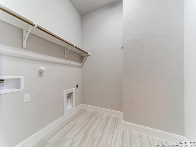 clothes washing area featuring laundry area, electric dryer hookup, baseboards, and washer hookup