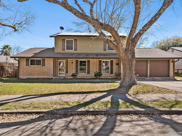 traditional-style home featuring fence, an attached garage, concrete driveway, a front lawn, and brick siding