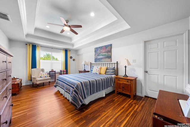 bedroom with visible vents, recessed lighting, baseboards, a raised ceiling, and dark wood-style flooring