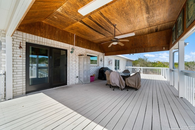 wooden deck with area for grilling and a ceiling fan