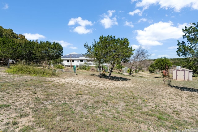 view of yard with a storage shed and an outbuilding