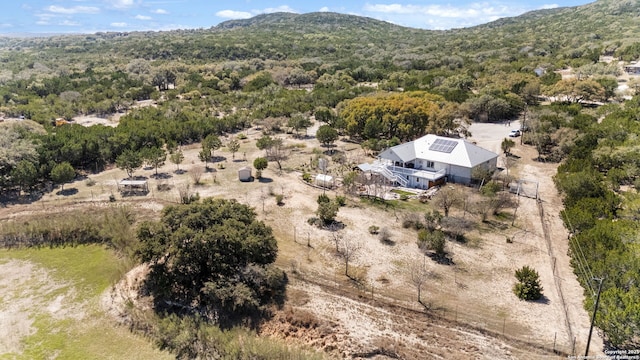 birds eye view of property featuring a view of trees and a mountain view